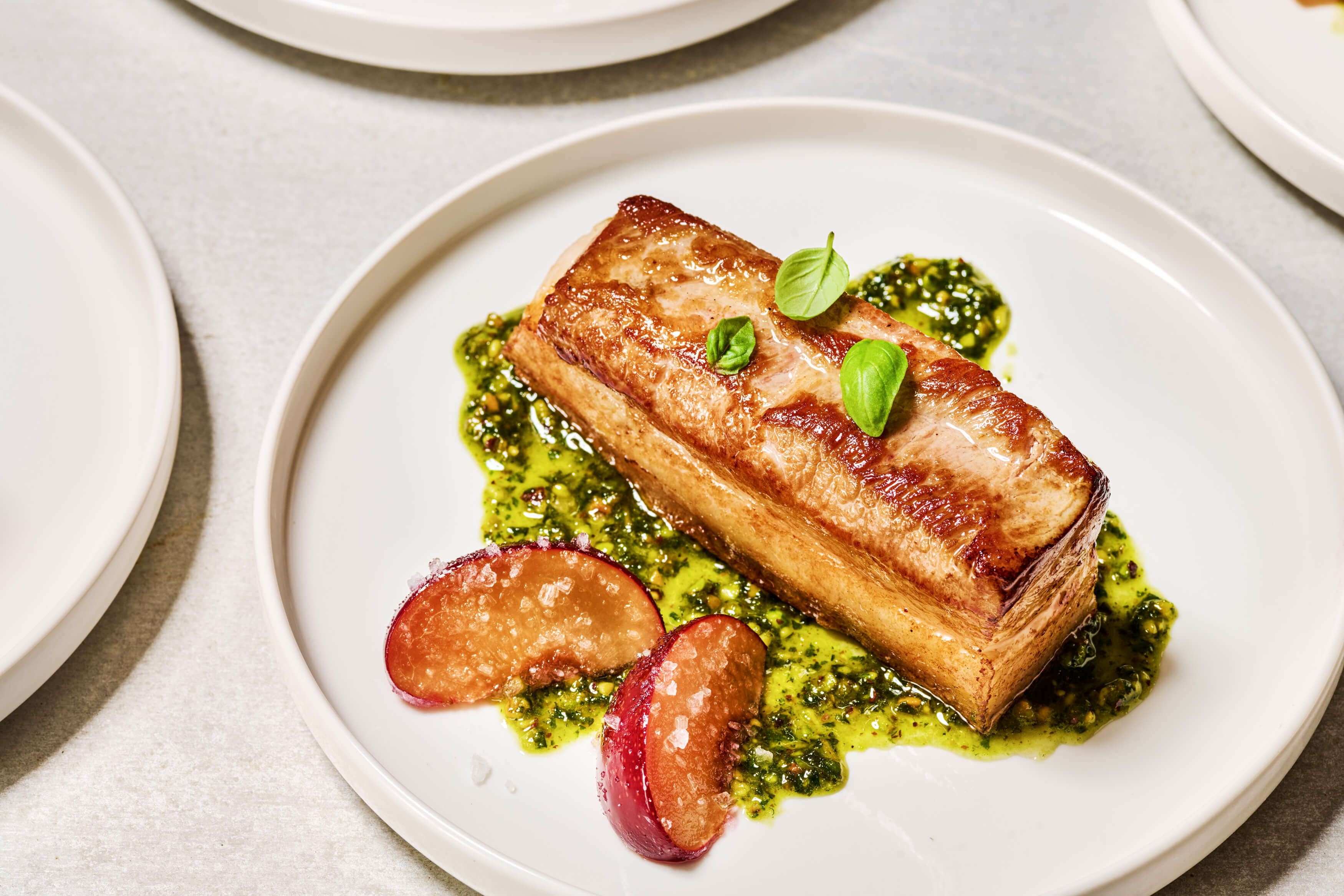 Roasted Sweet and Sour Pork Belly With Pistachio Pesto and Braised Plums